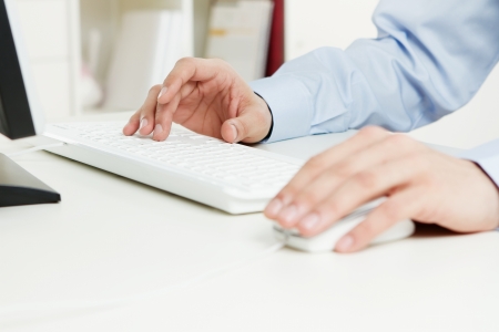 Close up of young adult working at the officeの写真素材