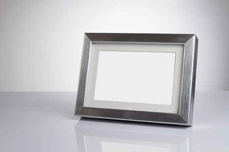 Blank silver picture frame at the desk with clipping pathの写真素材