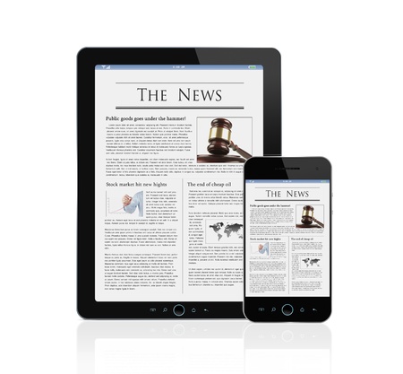 Latest news at digital tablet and smart phone isolated on whiteの写真素材