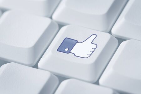 Thumbs up or like symbol at the computer keyboardの写真素材