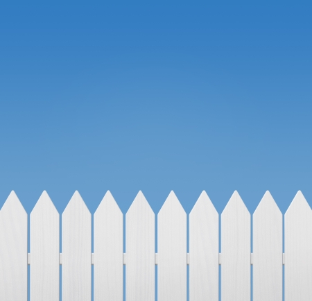 White wooden fence against blue sky with copy spaceの写真素材