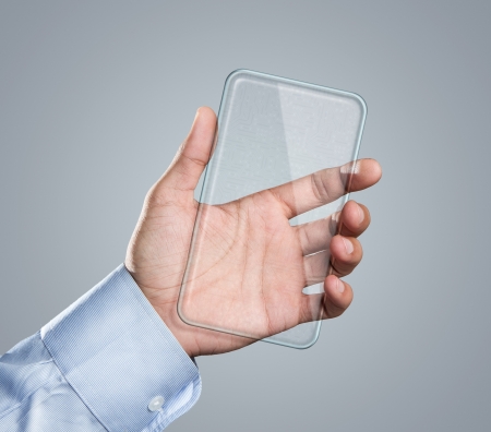 Male hand holding blank futuristic transparent smart phone with copy spaceの写真素材