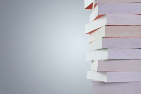 Stack of old used books isolated on gray background with copy spaceの写真素材