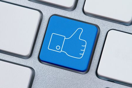 Thumbs up or like symbol at the computer keyの写真素材
