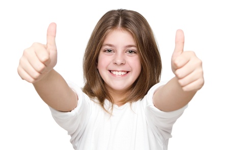 Little girl showing two thumbs up isolated on white backgroundの写真素材