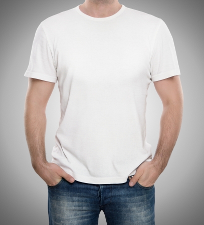 Man wearing blank t-shirt isolated on gray background with copy spaceの写真素材