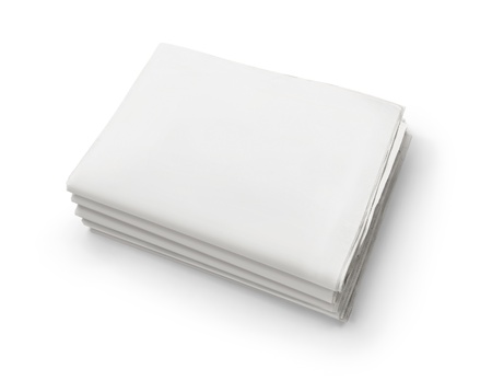 The news, stack of old blank business newspapers isolated on white background with copy spaceの写真素材