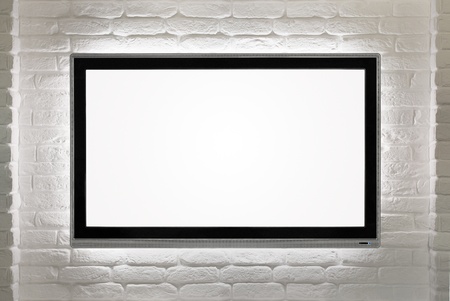 Blank modern flat screen TV at the white brick wall with copy spaceの写真素材