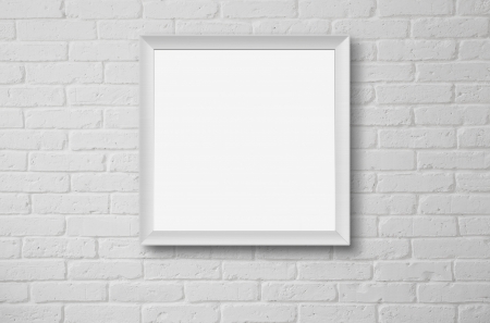 Blank picture frame at the white brick wall with copy space and clipping pathの写真素材
