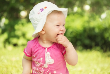 Portrait of cute little baby girl in the gardenの写真素材