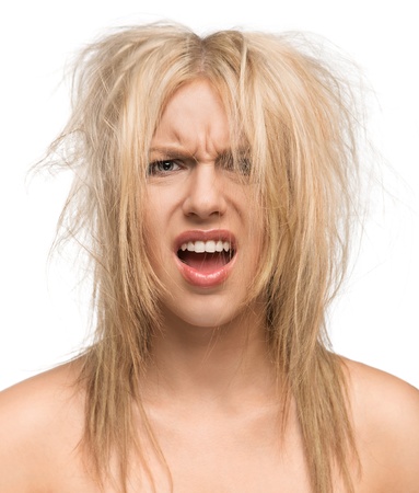 Bad hair day, portrait of a beautiful girl with messed up hair isolated on white backgroundの写真素材
