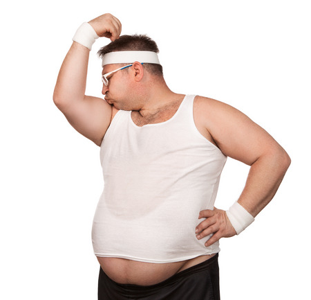 Funny overweight sport nerd kissing his bicep isolated on white backgroundの写真素材