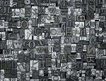 Letterpress background, close up of many old, random metal letters with copy space