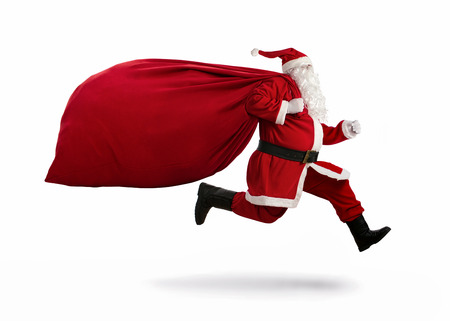Santa Claus on the run to delivery christmas gifts isolated on white backgroundの写真素材