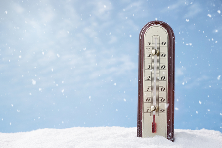 Close up of a thermometer in the snow with copy space