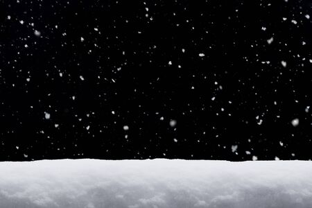Winter background. falling snow isolated on black background with copy spaceの写真素材