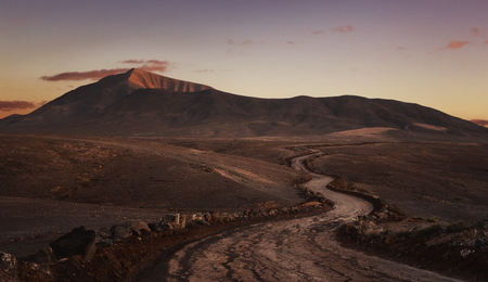 Empty desert road at the sunset with copy space. Papagayo beach, Lanzarote, Canary Islandの写真素材