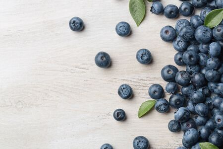 Freshly picked blueberries spilled on the wooden background with copy spaceの写真素材