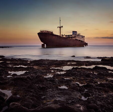 Shipwreck at the sunset on a Lanzarote coast with copy spaceの写真素材