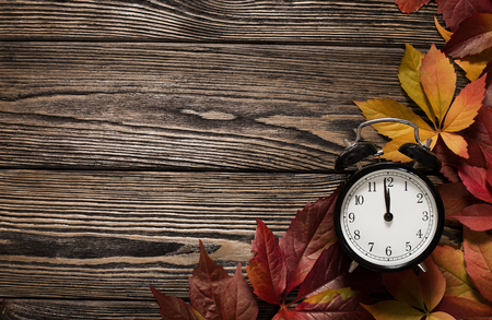 Time for autumn concept, close up of clock on wooden background with copy spaceの写真素材
