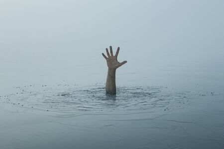 Danger, problems concept. Close up of human hand drowning in the lakeの写真素材