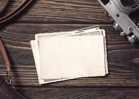 High angle view of a stack of old, blank photographs on the desk with copyの写真素材