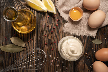 Preparing mayonnaise. High anle view of mayo with its ingredientsの写真素材