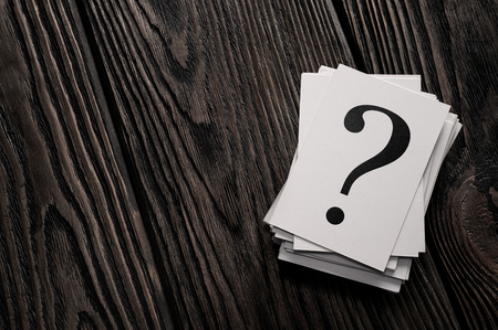 Stack of question mark cards on the wooden table with copy spaceの写真素材