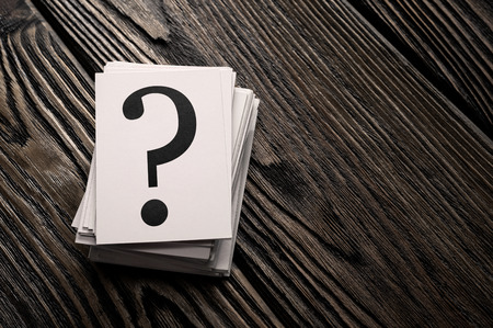 Stack of question mark cards on the wooden table with copy spaceの写真素材