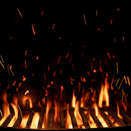 Empty grill grid with fire isolated on black background with copy spaceの写真素材