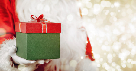 Close up of Santa Claus giving christmas gift with copy spaceの写真素材