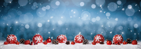 Panoramic christmas ornaments in the snow over winter backgroundの写真素材