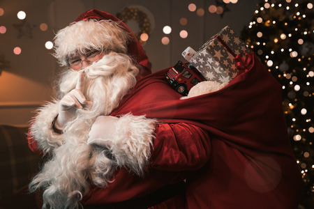 Santa Claus with finger on the lips gesturing silent signの写真素材