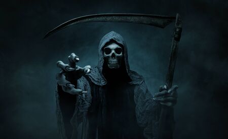 Grim reaper reaching towards the camera over dark, foggy background with copy spaceの写真素材