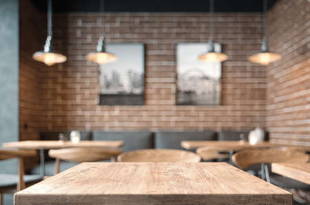 Empty coffee table over defocused coffee shop background with copy spaceの写真素材