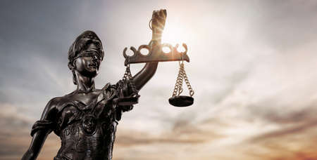 Close up of lady justice, Themis bronze figure over the sky background with copy spaceの写真素材