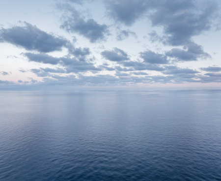 Aerial view of the calm sunrise over the ocean with copy spaceの写真素材