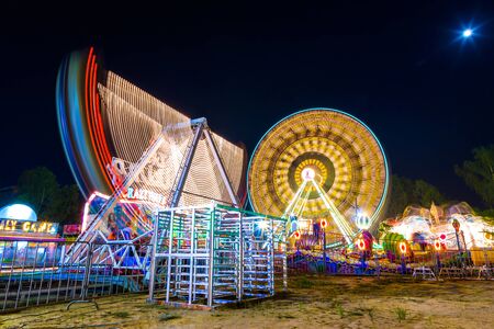 Amusement International park at night in Thailand. Fun Fair long exposure. Movement.のeditorial素材
