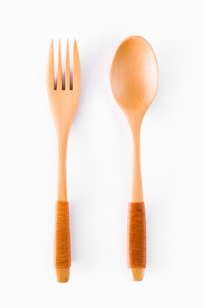 Spoons and forks made of wood split with a white background.の写真素材