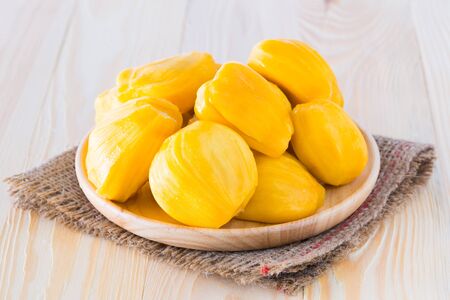 Jackfruit cooked on a plate that is made of wood and placed on a wooden floor.