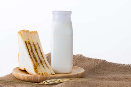 Bottle milk with sandwiches on white background.の写真素材
