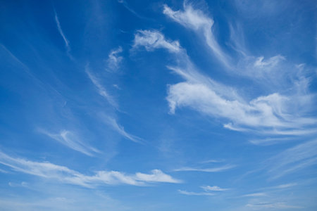 bright blue sky with the lightly floating cloudsの写真素材