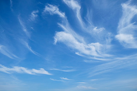 bright blue sky with the lightly floating cloudsの写真素材