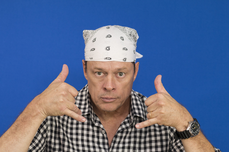 Man with white bandana and plaid shirt, black and white, full of expressionsの写真素材