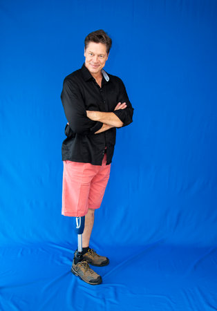 Mature man, physically disabled, leaning on his prosthesis.の写真素材