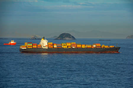 Cargo ship arriving in Rio de Janeiro with a hills in the backgroundの写真素材