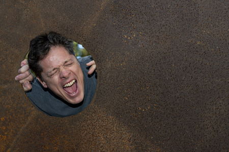 Businessman Shouting. Man with his head in a hole. He is having a headache, stress and overworked...