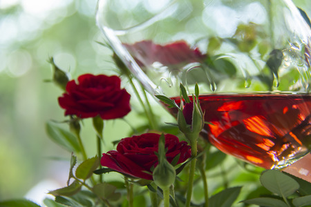 Beautiful rose glass of wine with roses on blurred background. Valentine's Day. Mothers Day. Romantic gift. Romance. Love.の写真素材