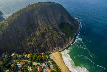 Stone beach and mountain. Beach paradise. Itacoatiara beach. The city of Niteroi, State of Rio de Janeiro Brazil, South America.の写真素材