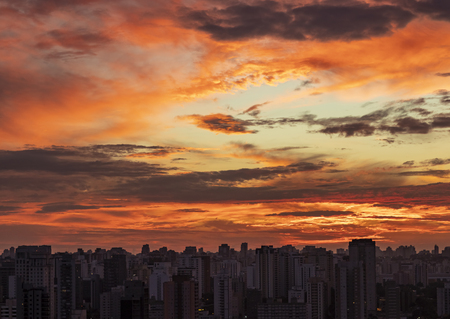 Sunset in city with industrial skyline and clouds, fire sky.の写真素材